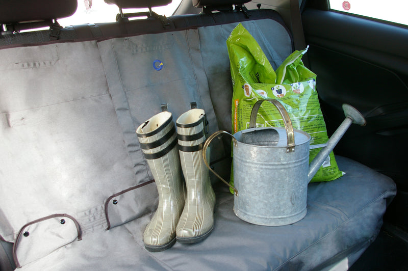 Bench rear seat cover in vehicle protected from gardening tools and dirty boots placed on the seat